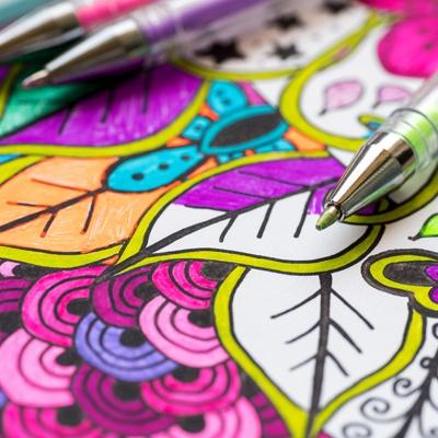an adult coloring page with colored pens